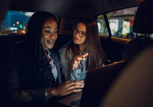 Two women conduct business in the back of the car after calling for Local Taxis in East Peoria IL