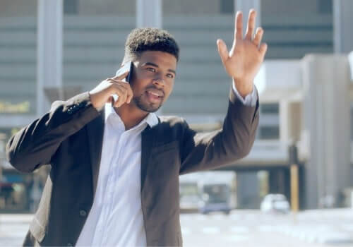 A business man waves down a taxi after calling Curt's Transportation Services, a Taxi Company Morton IL relies on.