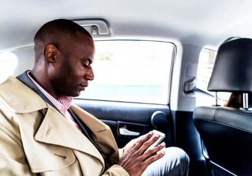 A man sits in the back of one of Curt's Transportation Services after calling them for Taxi Service in Morton IL