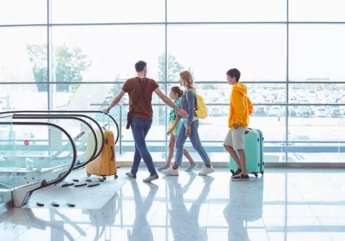 A family heads home from the airport with their luggage. If you're asking "How Do I Get Home from Peoria International Airport" make the call to Curt's Transportation Services.