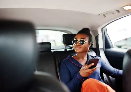 A woman looks out the window in the back of a cab from Curt's Transportation Services, which offers Taxi Service in Woodford County IL